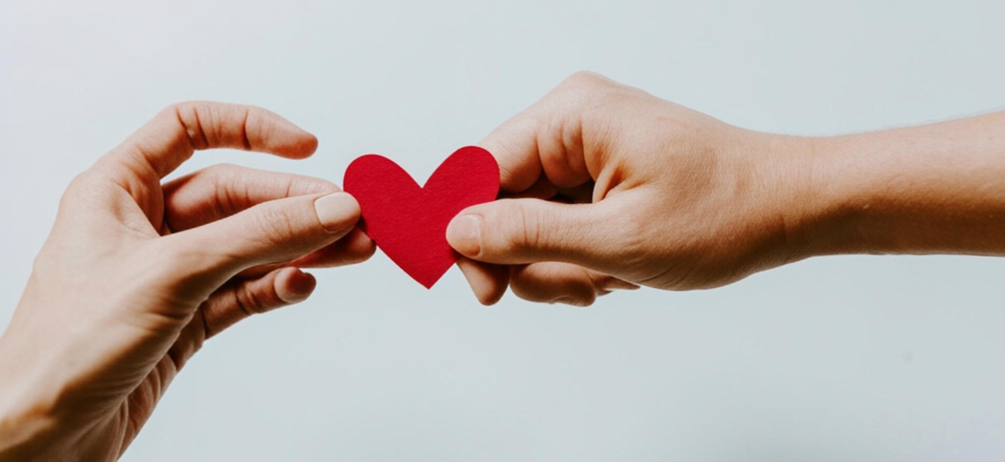 Hands exchanging a heart